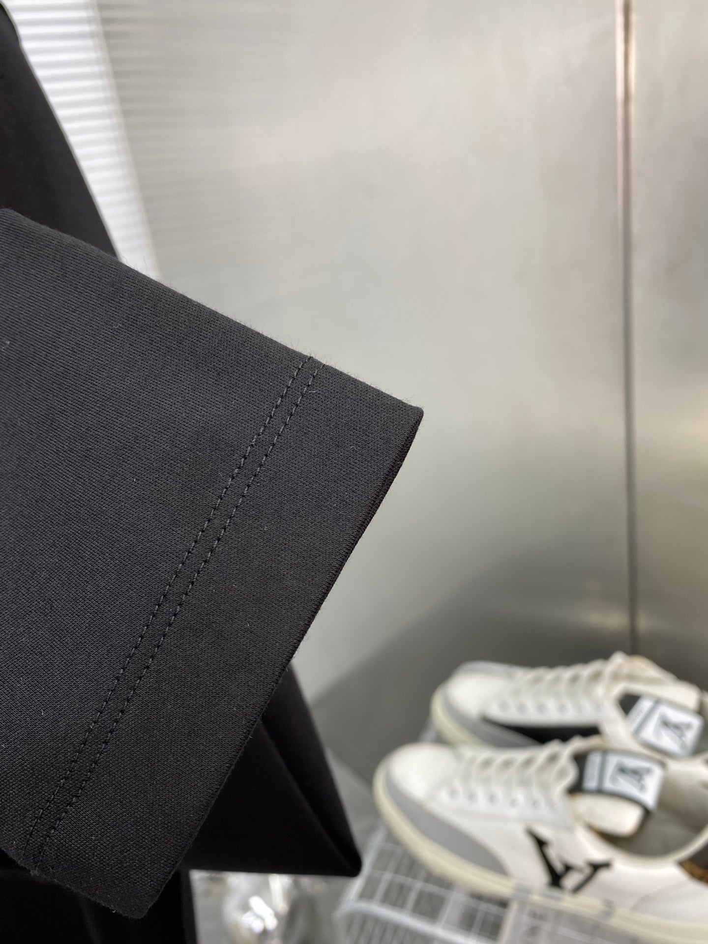 Black long-sleeve T-shirt sleeve hem detail