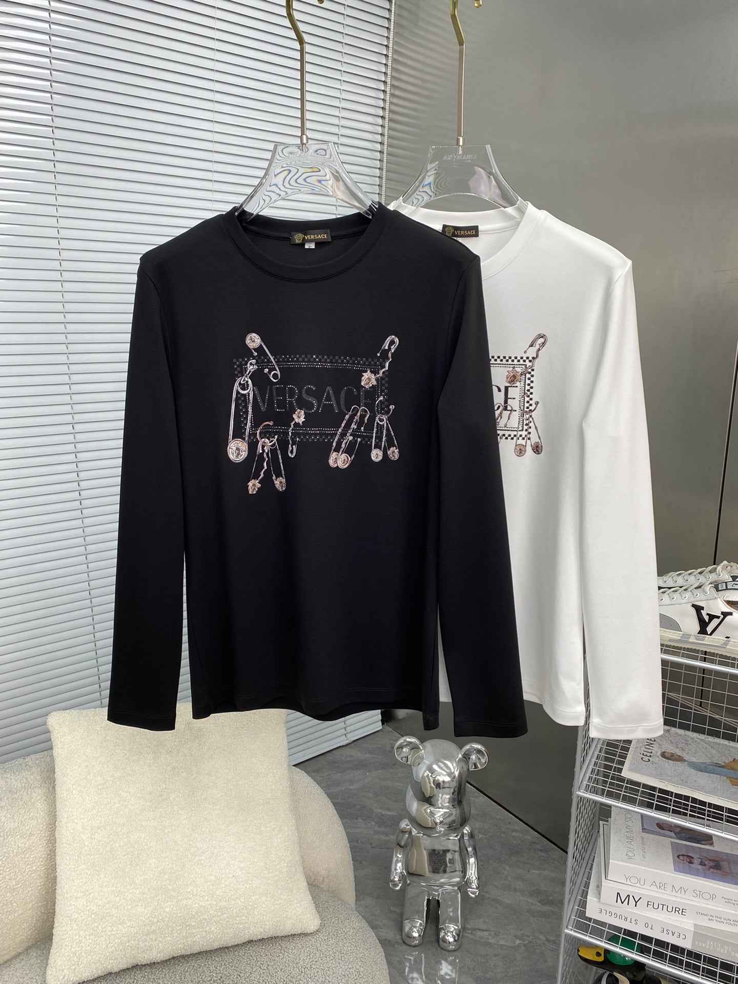 Black and white long-sleeve T-shirts with Versace charm graphics