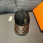 Louis Vuitton baseball cap, black top with monogram pattern and yellow LV emblem, front view
