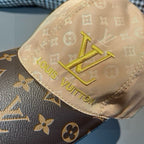 Louis Vuitton monogram cap close-up, tan crown with gold LV and Louis Vuitton text