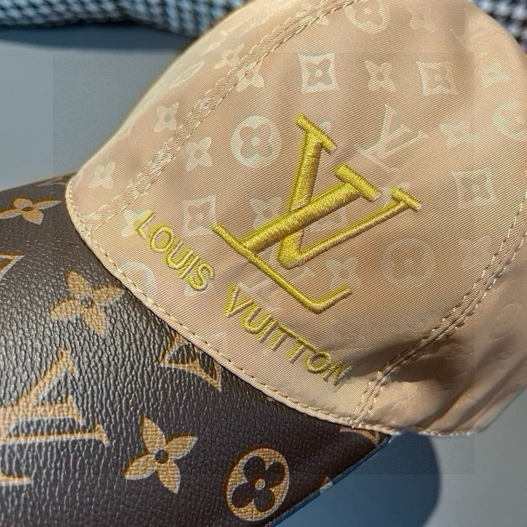 Louis Vuitton monogram cap close-up, tan crown with gold LV and Louis Vuitton text