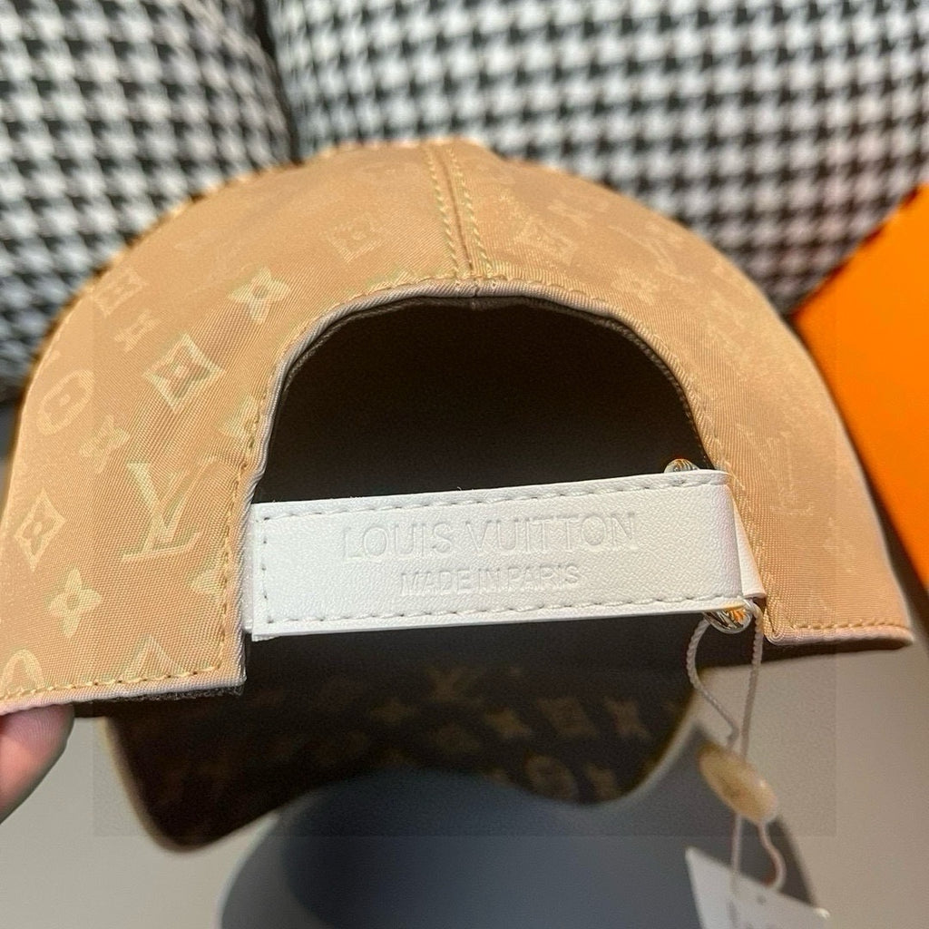 Louis Vuitton monogram baseball cap with tan crown, dark brim, adjustable strap
