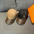 Pair of Louis Vuitton monogram baseball caps, tan and dark with gold LV logos