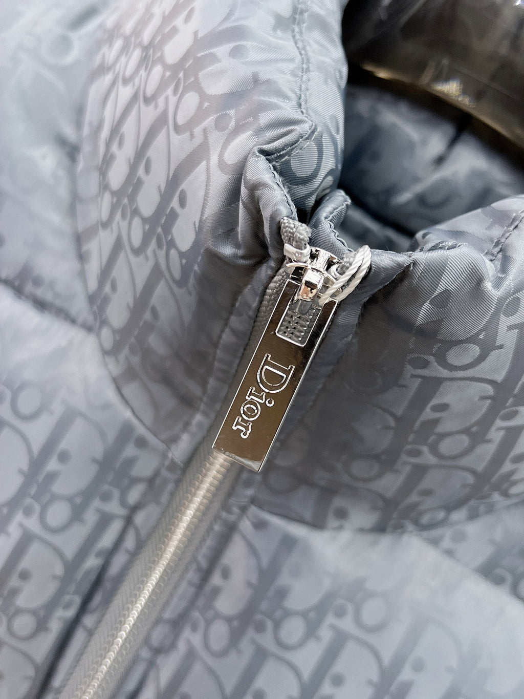 Long puffer jacket zipper pull close-up with Dior tag on gray-blue lining