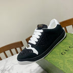 Black and white Gucci low-top sneaker with white laces and speckled glitter side