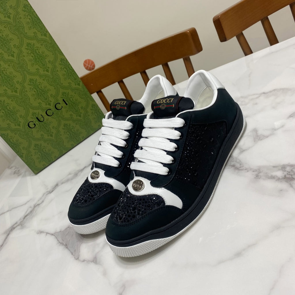 Black and white low-top Gucci sneakers with white laces and side logo detail