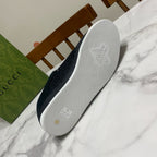 Black Gucci sneaker outsole with textured grip and embossed bee logo