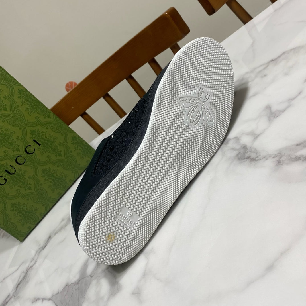 Black Gucci sneaker outsole with textured grip and embossed bee logo
