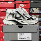 Unisex white lace-up sneakers with black side stripes and textured upper