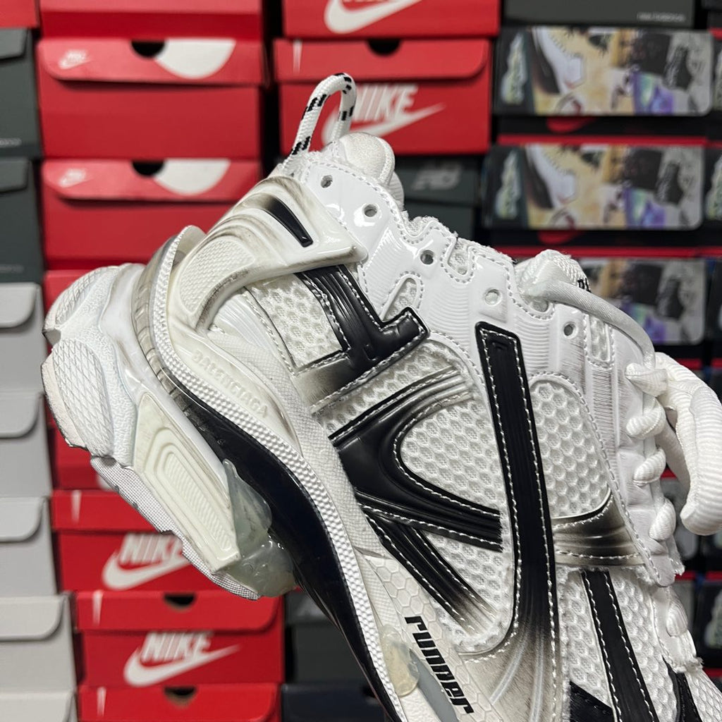 Unisex white lace-up sneaker with black side stripes and thick cushioned sole