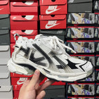 Unisex white lace-up sneakers with black logo stripes and chunky sole