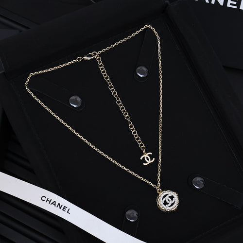 Gold-tone Chanel pendant necklace with chain links and round CC charm