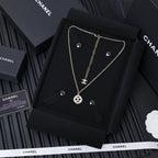 Gold-tone Chanel pendant necklace on black card, round CC charm and chain