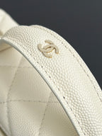 Chanel logo on quilted cream leather strap, textured grain detail