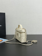 Chanel quilted leather mini bag, cream, side view with top handle and chain
