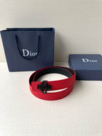 Red leather Dior belt with silver-tone buckle, shown as a coiled loop.
