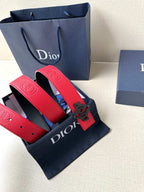 Red leather belt with silver buckle, laid with visible strap texture and hole spacing.