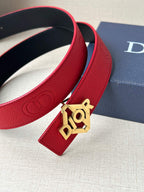 Close-up of red leather belt with silver buckle and dark inner lining at the edge.