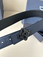 Dark blue leather belt close-up with black Dior logo buckle and textured strap.