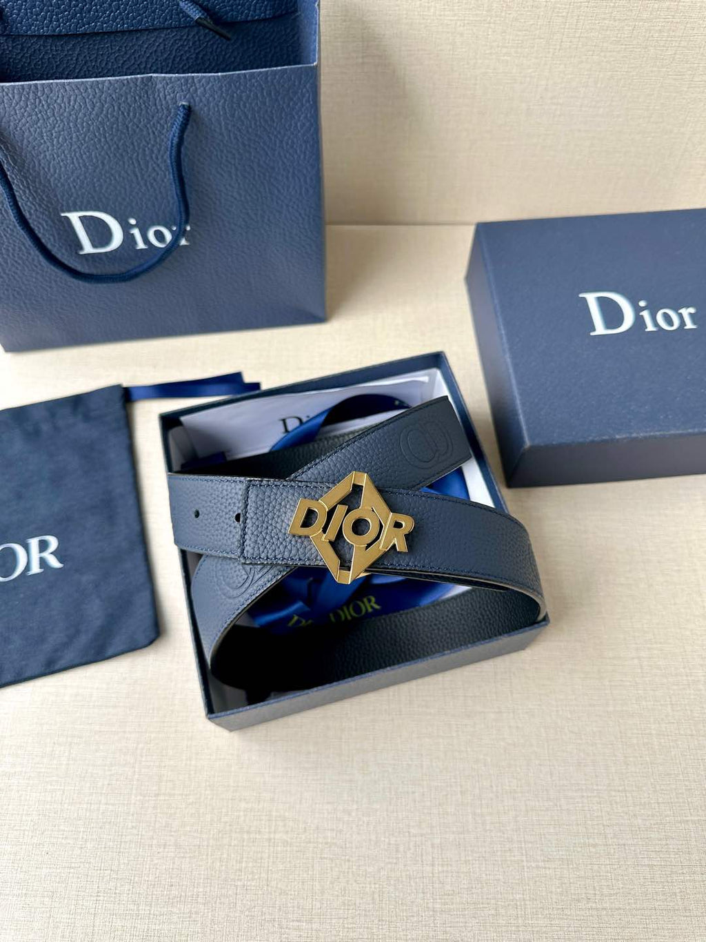 Dark blue leather Dior belt with Dior logo buckle in a gift box.