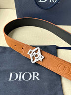 Dior belt close-up: tan strap with silver logo buckle and embossed pattern
