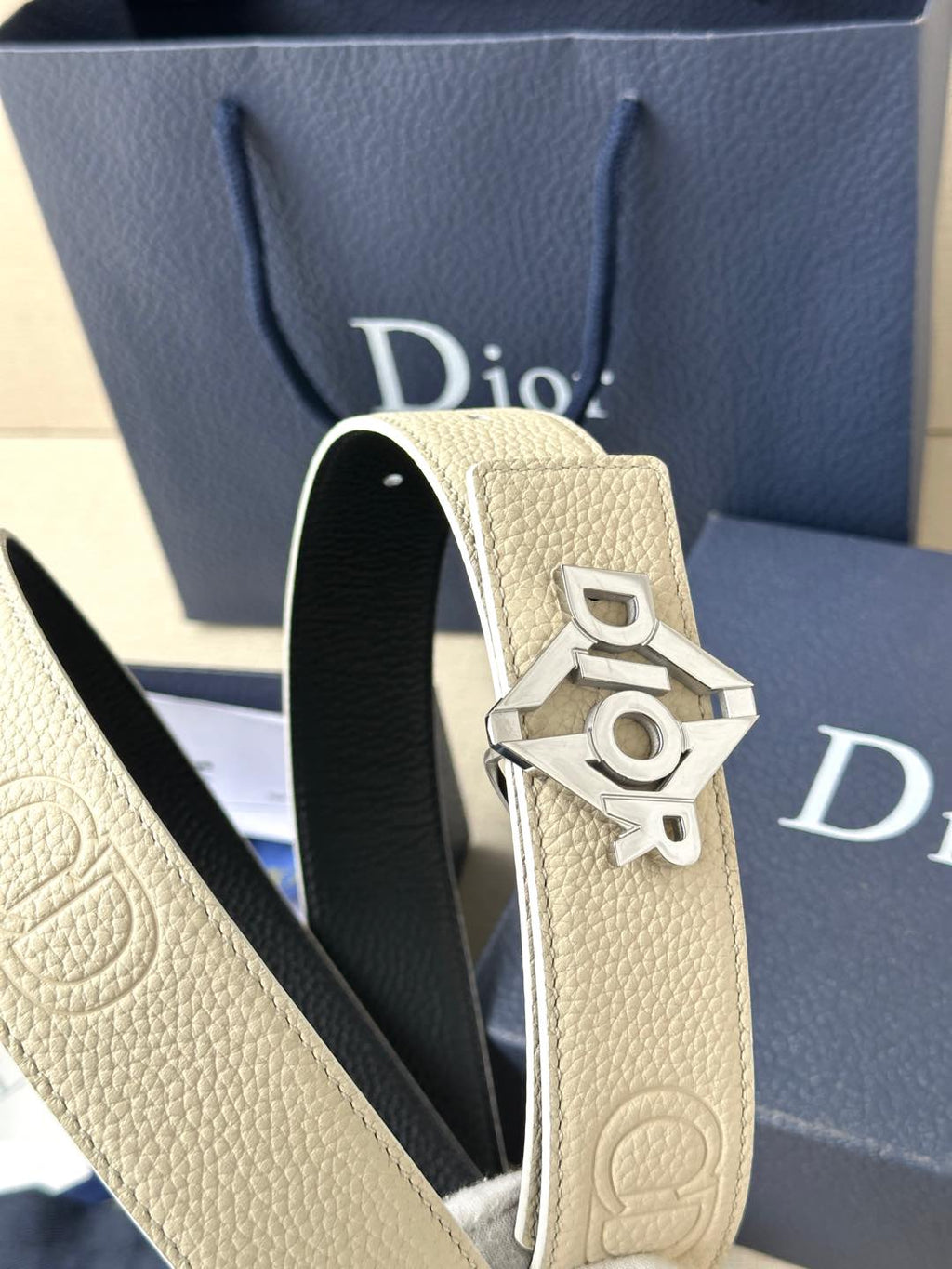 Ivory textured leather belt with silver Dior logo buckle close-up