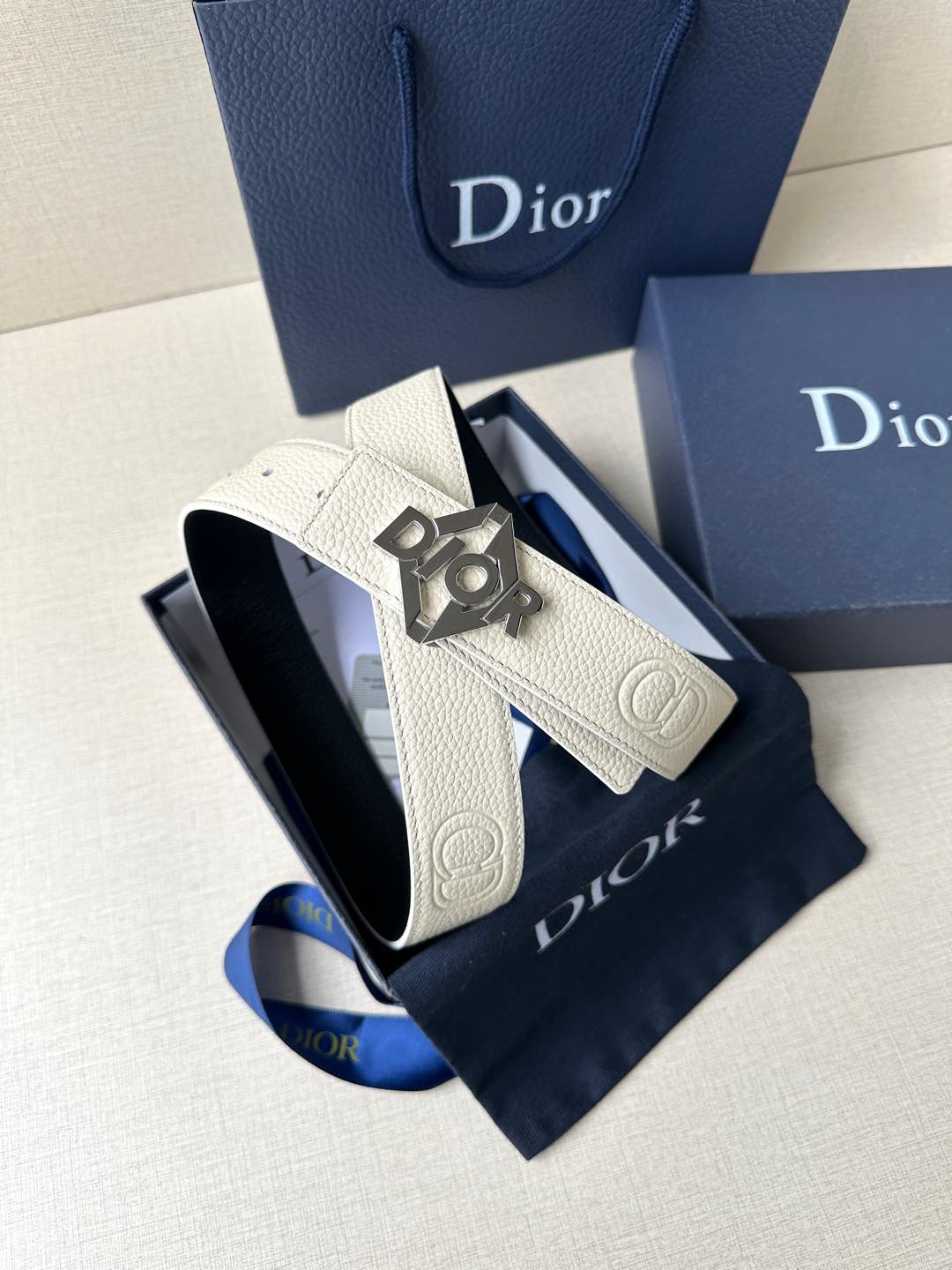 Ivory leather belt with dark Dior buckle and textured strap