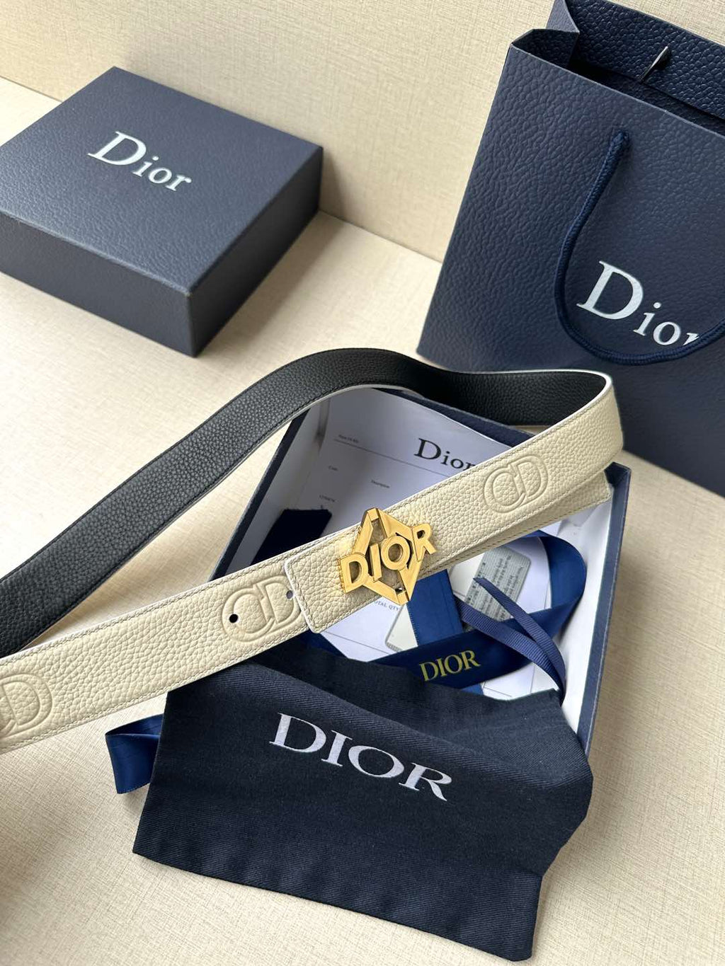 Ivory Dior belt with textured strap and gold-tone logo buckle