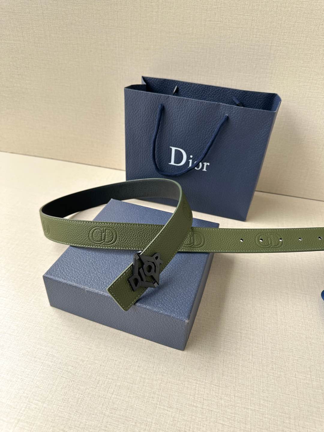 Dior leather belt in olive green with logo buckle and multiple adjustment holes