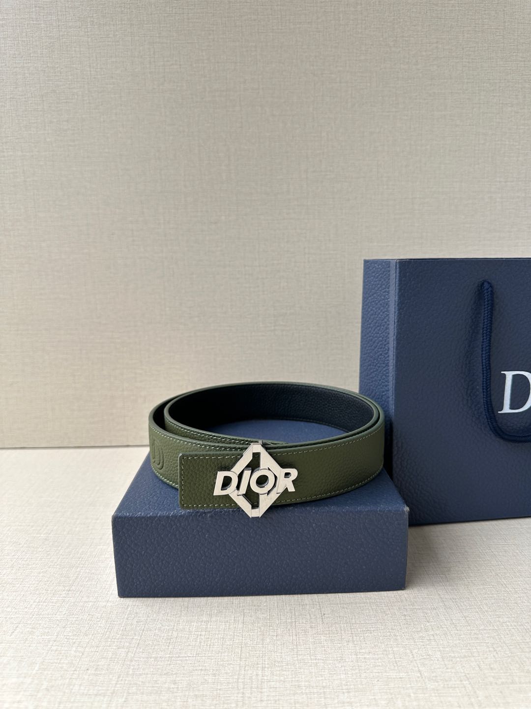 Dior leather belt with olive green strap and dark logo buckle