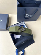 Dior leather belt in olive green with logo buckle resting on a box and dust bag
