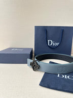 Dior belt in light blue leather with silver buckle, near Dior gift bag