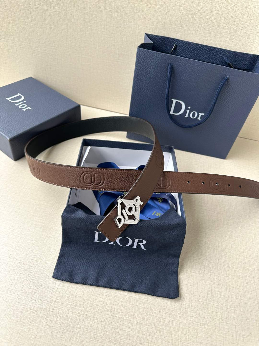 Dior belt with brown leather strap and gold-tone Dior logo buckle.