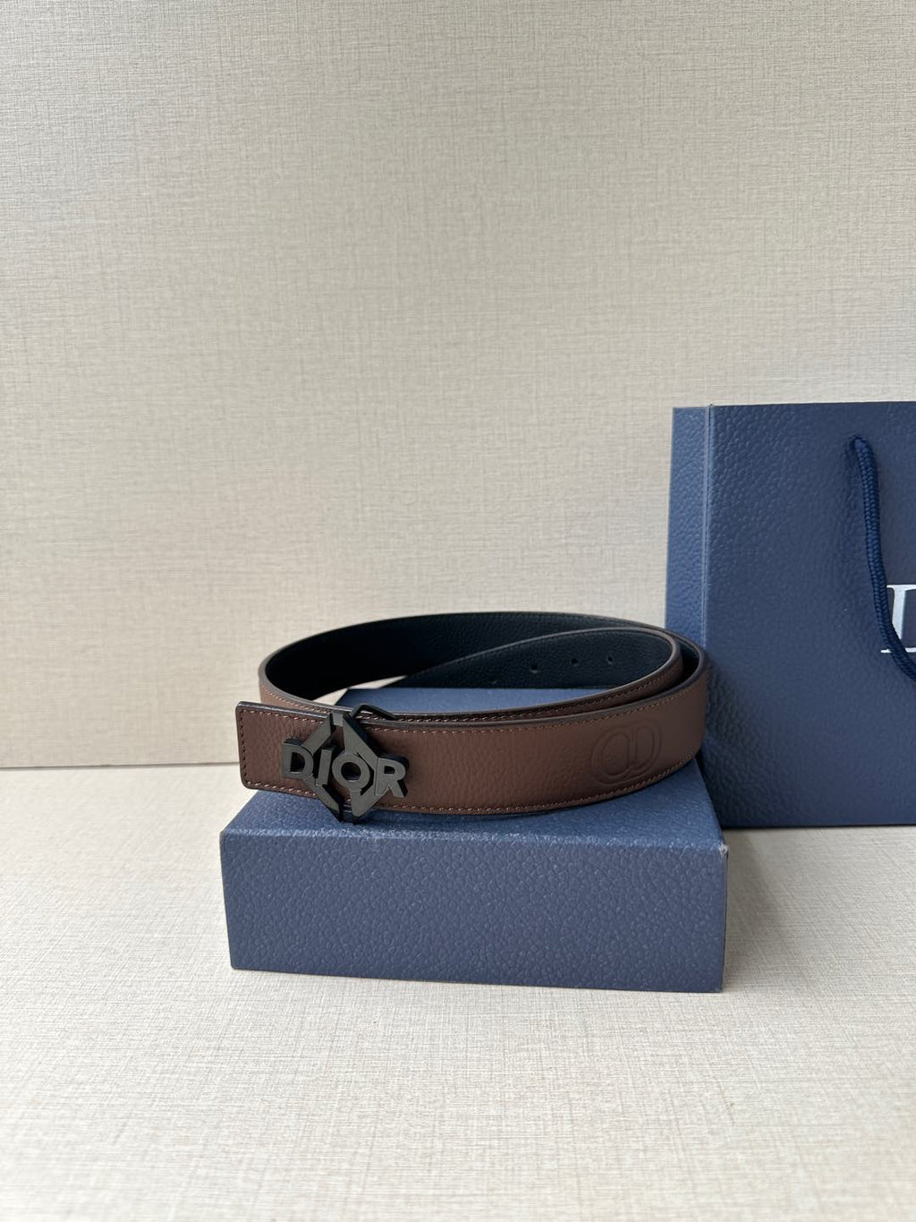 Dior belt with dark brown leather strap and gold-tone Dior logo buckle.