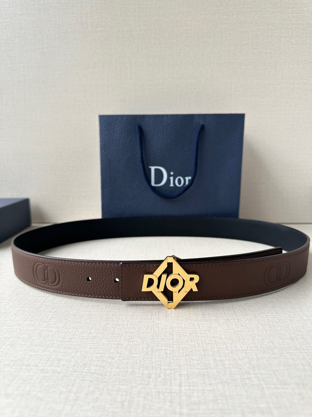 Dior belt, dark brown leather, gold-tone Dior logo buckle with punched holes.