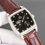 Rectangular wristwatch with black dial, brown leather strap, gold-tone case, diamond markers