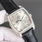 Square-rectangular wristwatch with black leather strap, silver-tone case, white dial details
