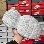 White sneaker bottom with detailed rubber tread and raised traction shapes