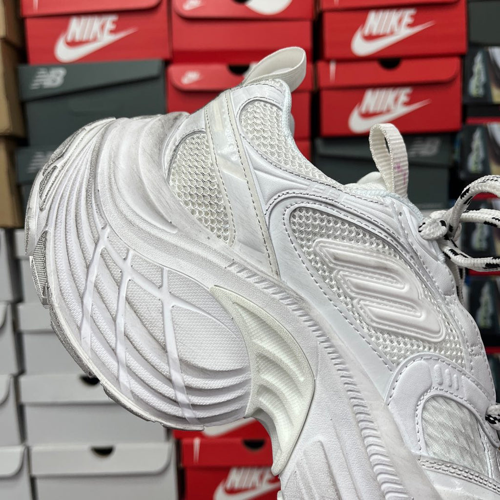 White lace-up sneaker with textured toe and ridged side panels