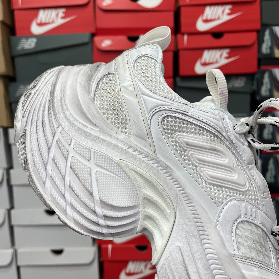White lace-up sneaker with textured toe and ridged side panels