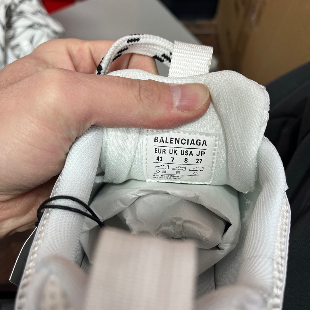White sneaker interior tongue label with BALENCIAGA size chart and barcode