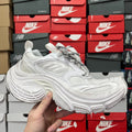 White athletic sneaker with textured side panel and lace-up front