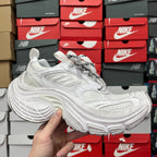 White athletic sneaker with textured side panel and lace-up front