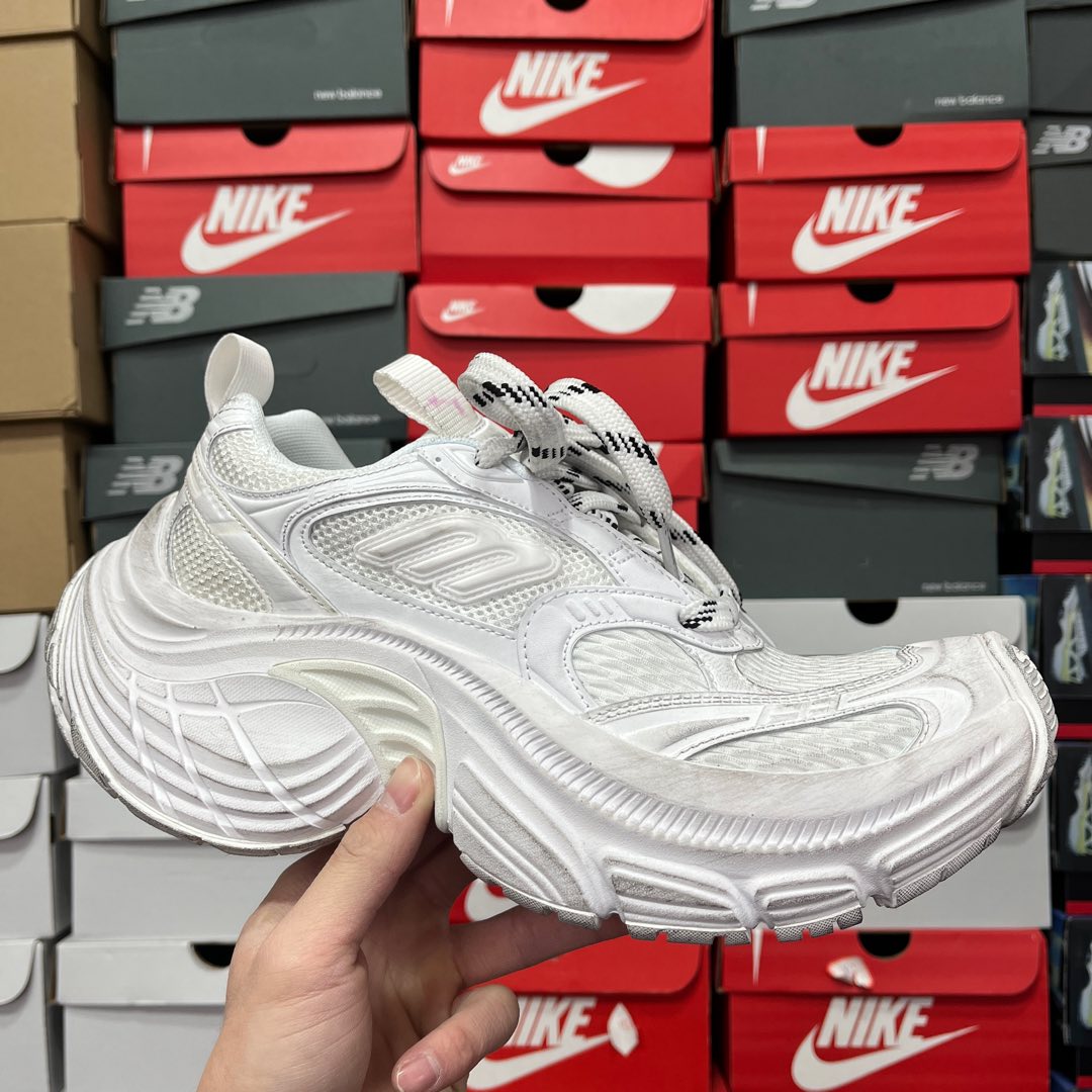 White athletic sneaker with textured side panel and lace-up front