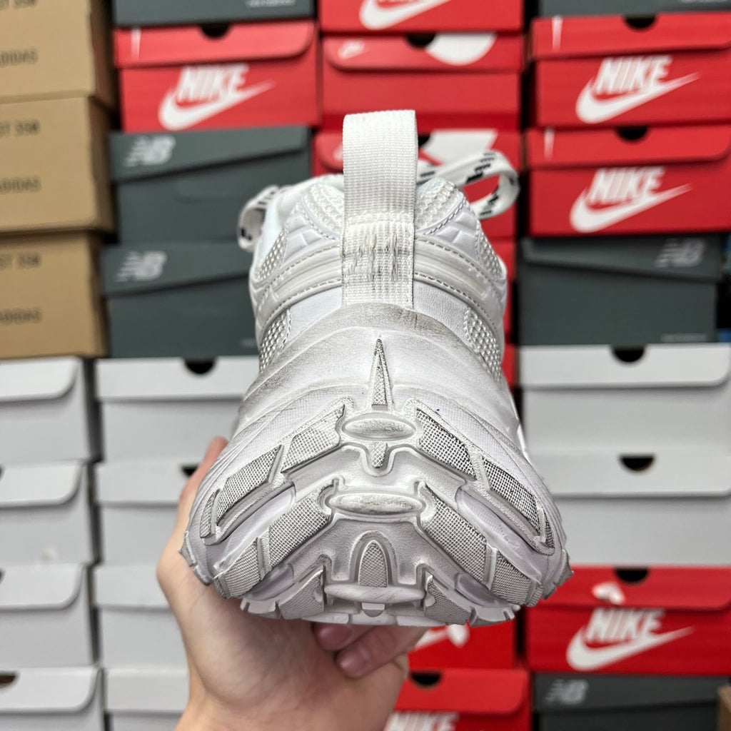 White sneaker outsole with molded traction pods and cushioned heel