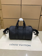 Monogram duffel bag with dual top handles and adjustable crossbody strap, dark leather
