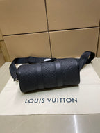 Monogram duffel bag front view with rounded top and shoulder strap, dark leather