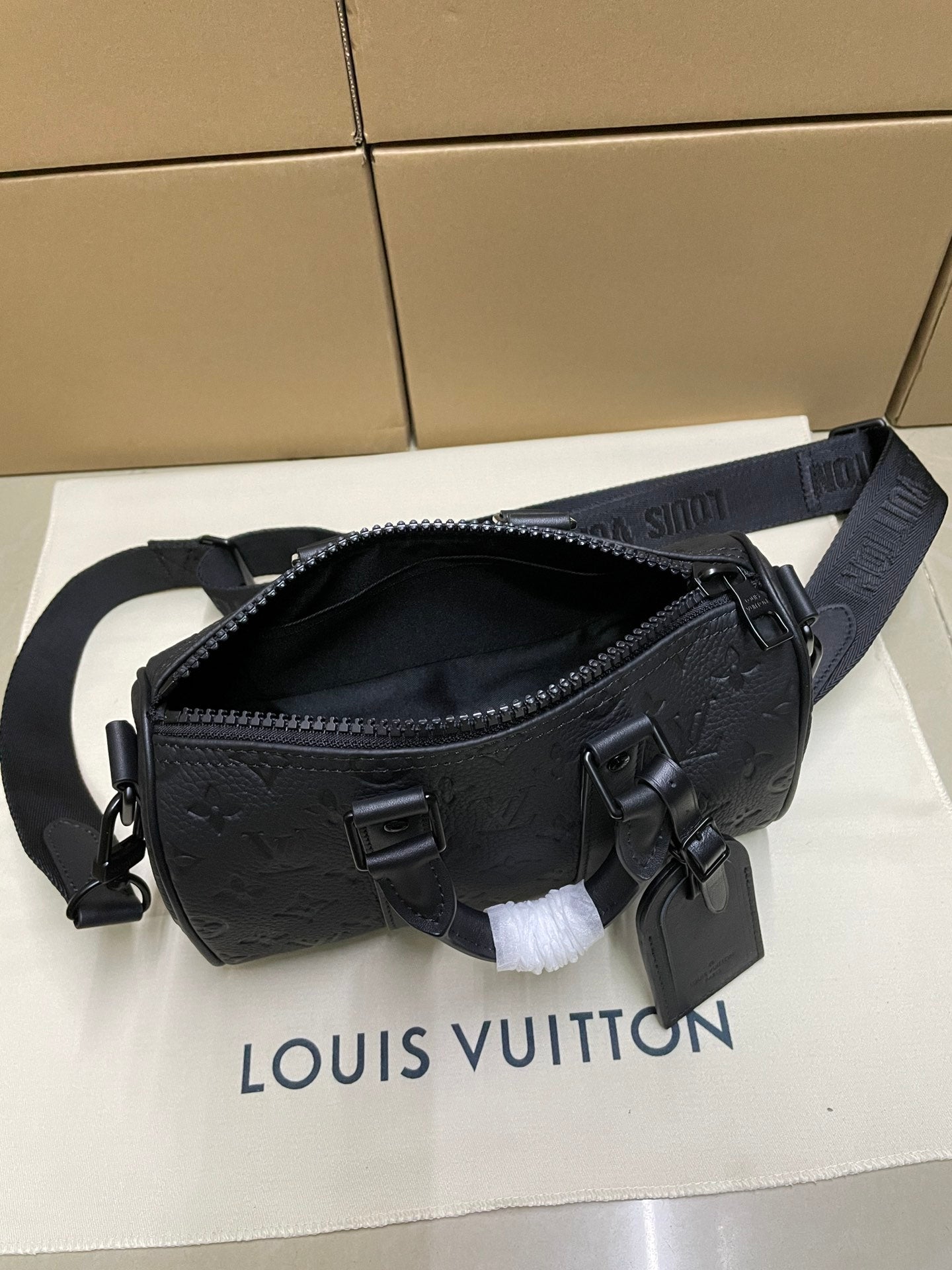 Monogram crossbody bag with zipper top and adjustable strap, dark leather and hardware