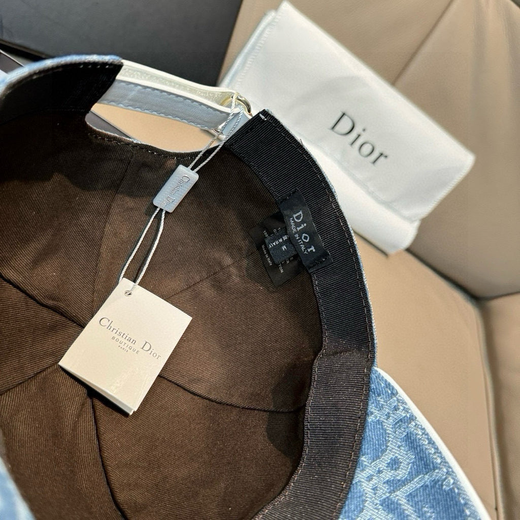 Dior cap in blue monogram denim with black strap and hanging tags