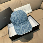 Dior cap in blue denim with monogram pattern, shown on gift box